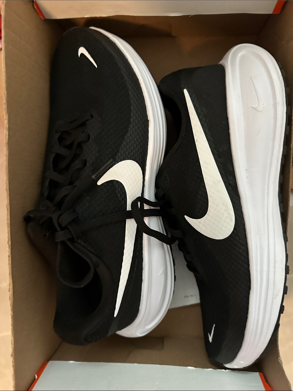 Women’s size 9w Nike Black and White Running Sneakers with White Swoosh